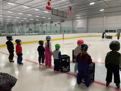 a group of people wearing helmets and ice skates