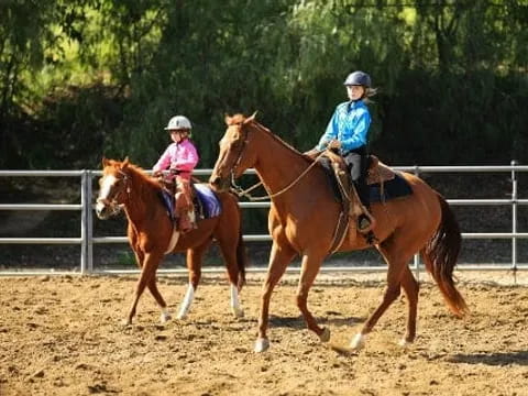 a couple of people ride horses