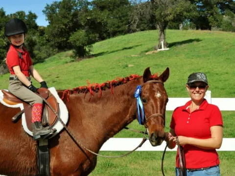 a person and a boy riding a horse