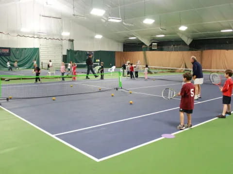 kids playing tennis in a court