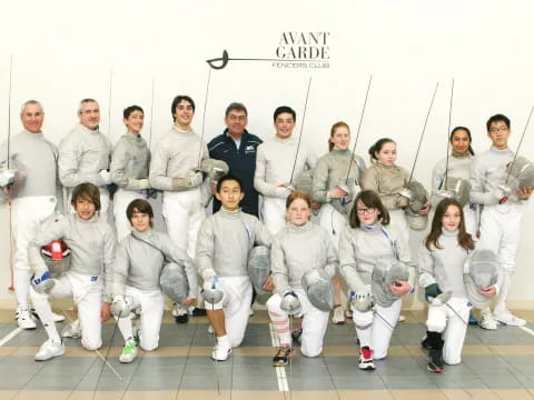 a group of people in white karate uniforms posing for a photo