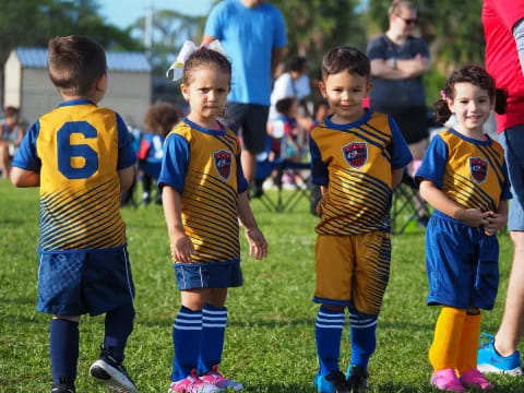a group of children in football uniforms