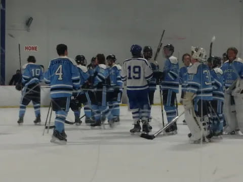 a group of hockey players posing for a photo