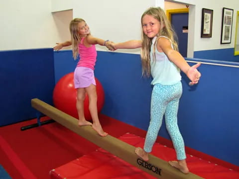 two girls on a red mat