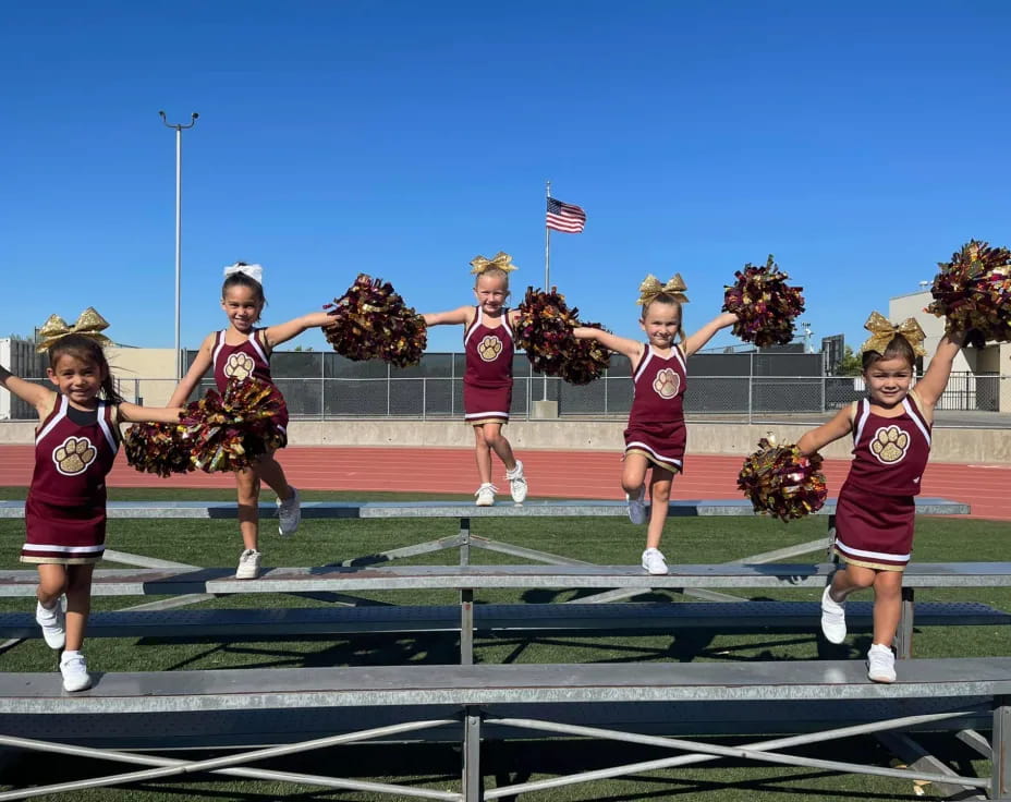 a group of cheerleaders on a track
