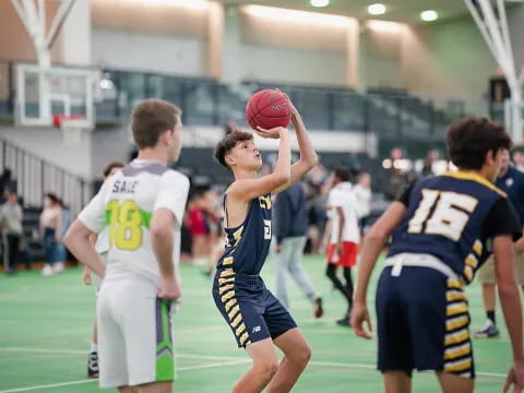 a group of people playing basketball