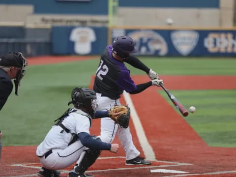 a baseball player hitting a ball with a bat