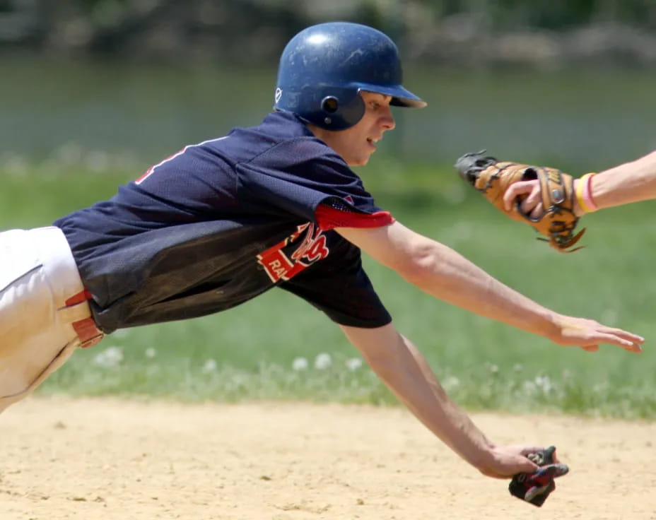a baseball player sliding into the base