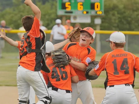 a group of people playing baseball