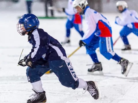 a group of people playing ice hockey
