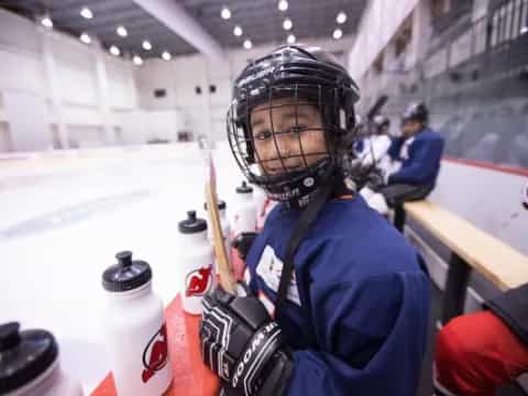 a person wearing a helmet and holding a hockey stick