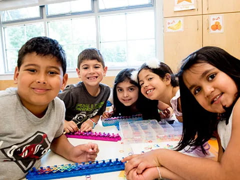 a group of children sitting at a table