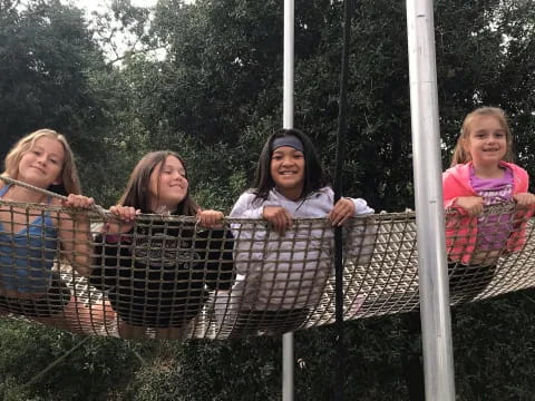 a group of girls on a swing