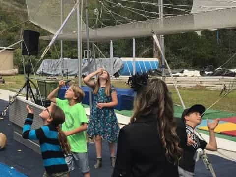 a group of people playing on a trampoline