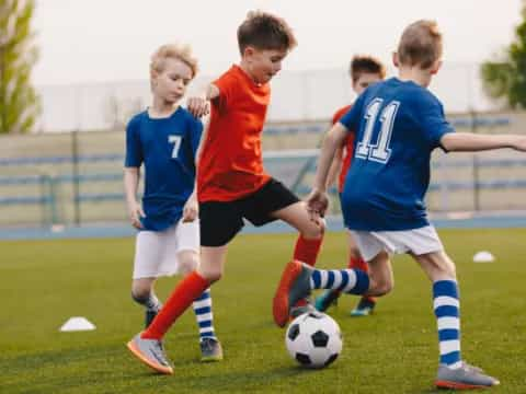 a group of kids playing football