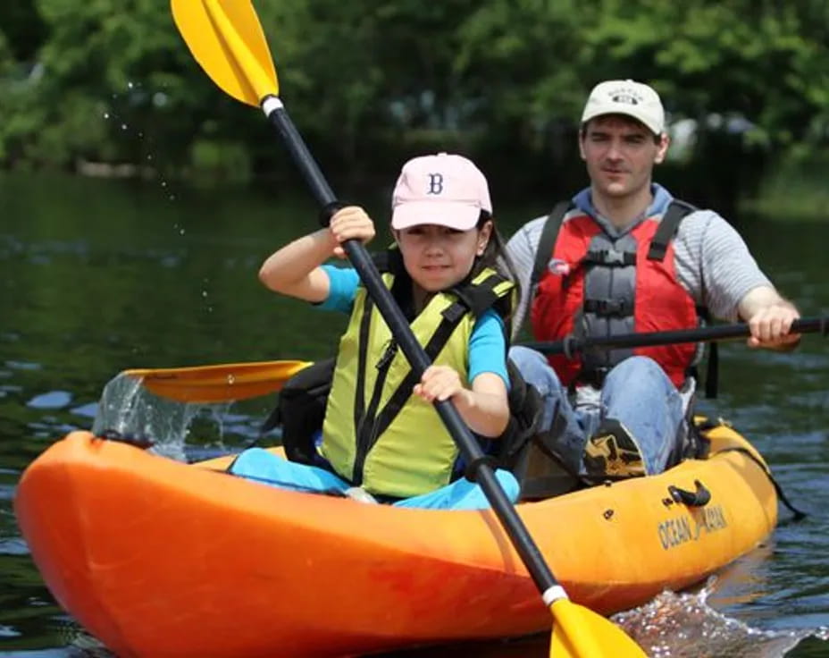 a person and a boy in a canoe