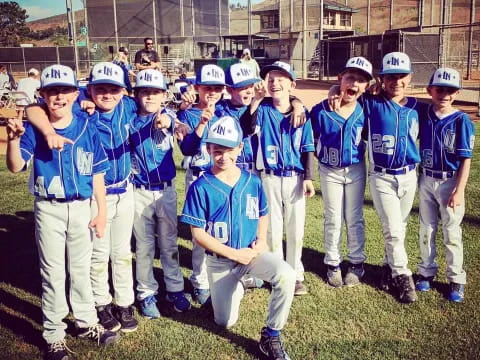 a group of kids wearing baseball uniforms