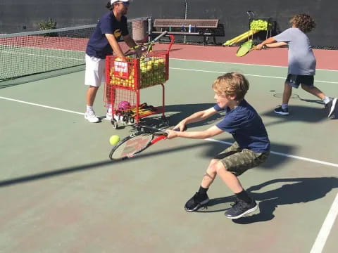 a kid swings a tennis racket