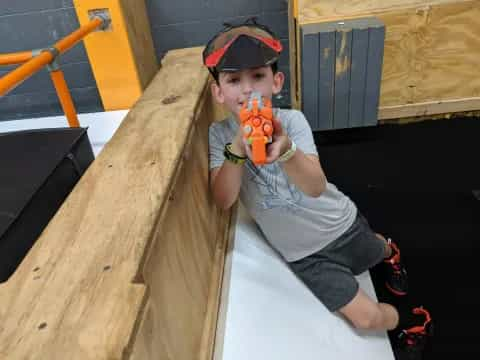 a boy holding a toy gun