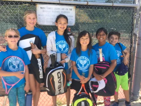 a group of girls wearing blue shirts