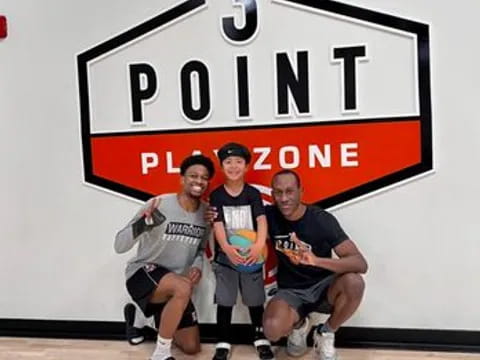 a group of men posing for a picture in front of a sign