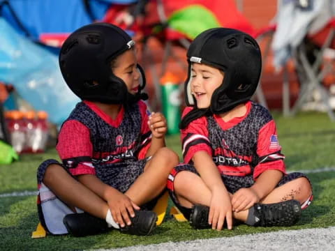 a couple of young girls wearing helmets