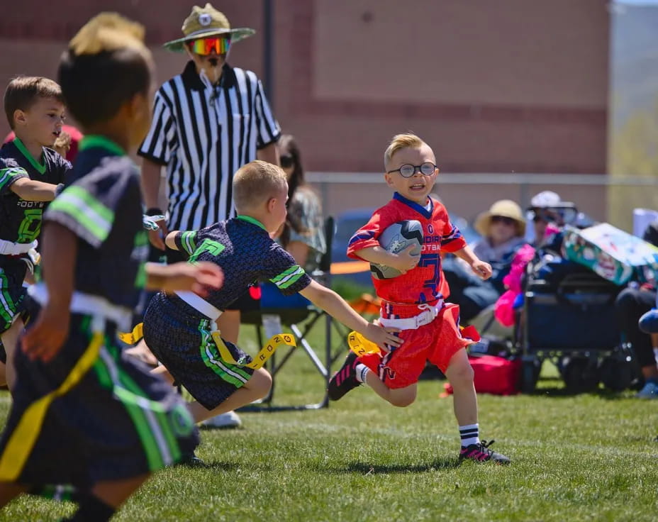 a group of kids playing football