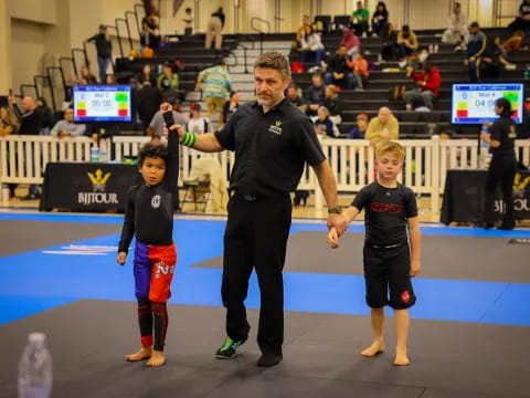 a person standing with two boys