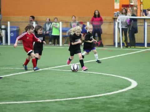 girls playing football on a field