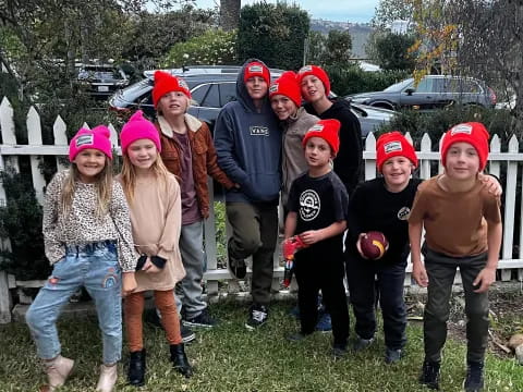 a group of people wearing red hats