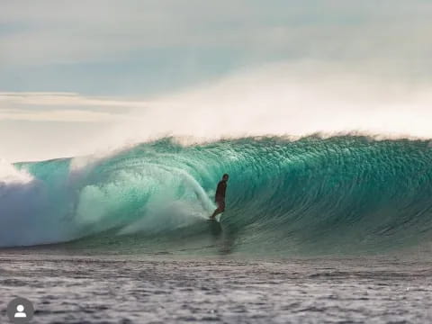 a surfer riding a large wave