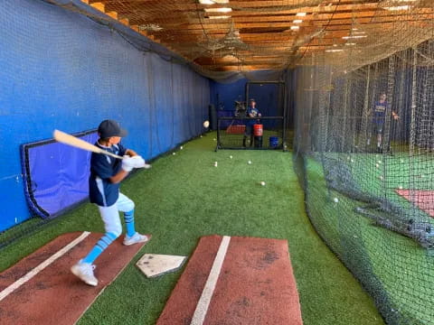 a baseball player prepares to swing a bat