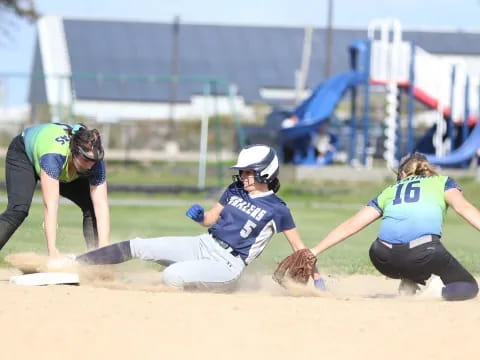 a person sliding into a base