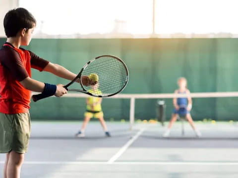 a kid playing tennis