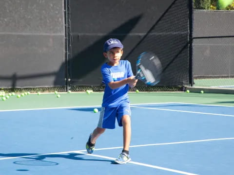 a boy playing tennis