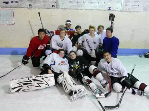 a group of hockey players posing for a photo