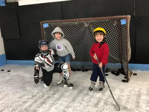 a group of kids playing hockey