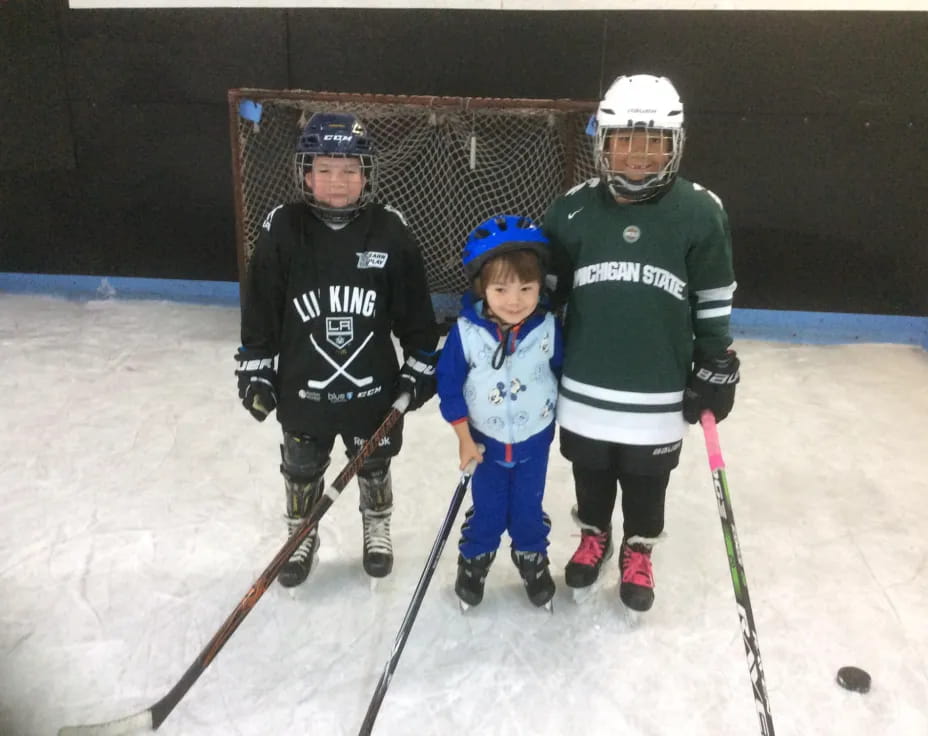 a group of kids wearing hockey gear