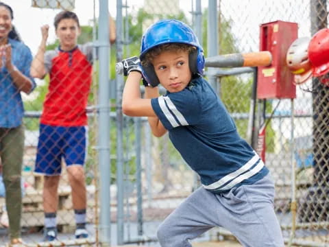 a kid swinging a baseball bat