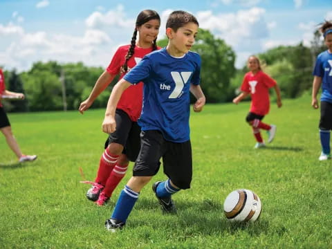 a group of kids playing football