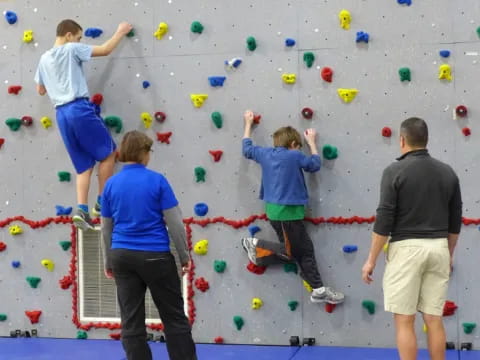 a group of people climbing a rock wall