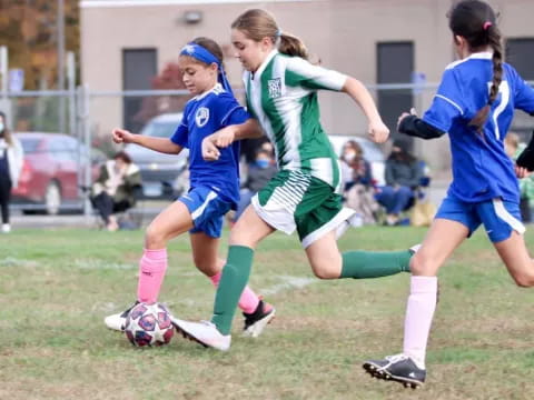 girls playing football on a field