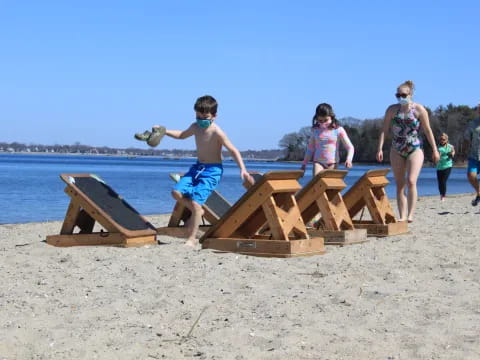 a boy playing with sand on a beach