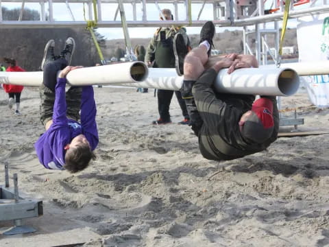 a couple of people doing push ups on the beach