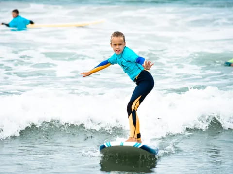 a kid on a surfboard in the ocean