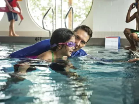 a man and woman in a pool