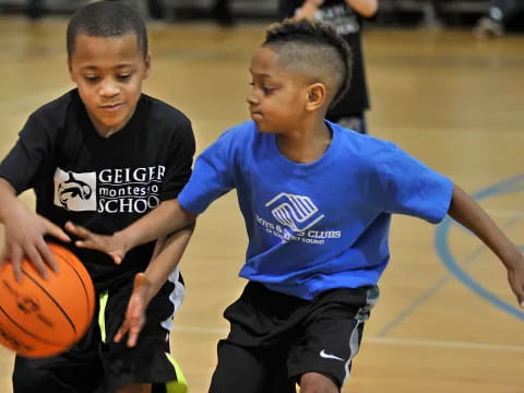 a couple of boys playing basketball