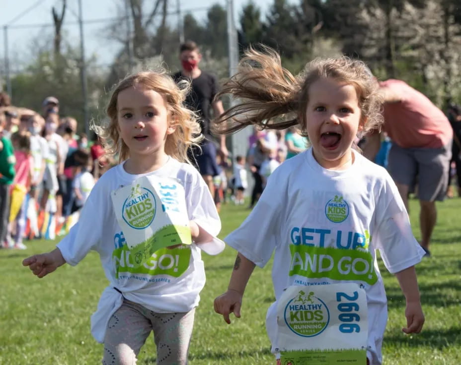 a couple of children running in a race