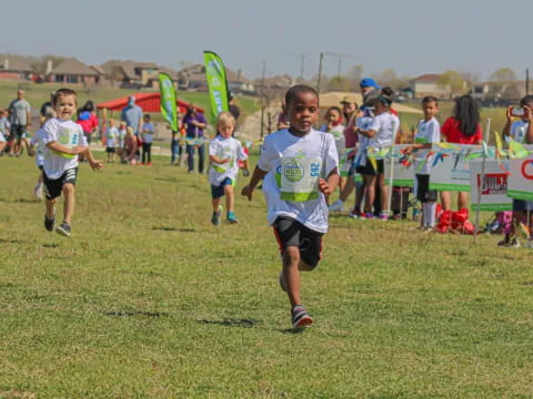 a group of children running on a field