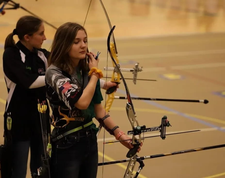 a couple of women shooting bows